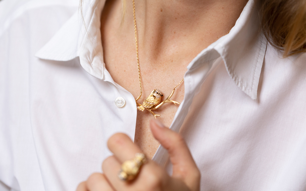 Chickadee necklace with a delicate chain and a sculpted gold branch
